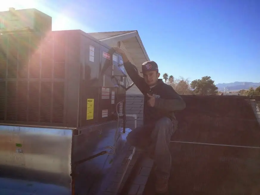 HVAC technician performing HVAC Inspection on a rooftop unit in Brooklyn
